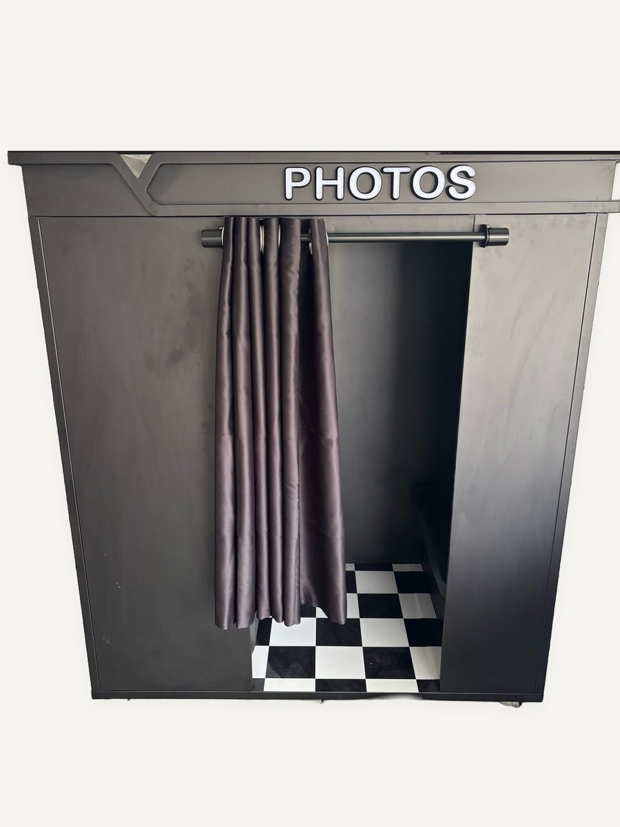 Front entrance of the photo booth, curtain open and checkered floor visible