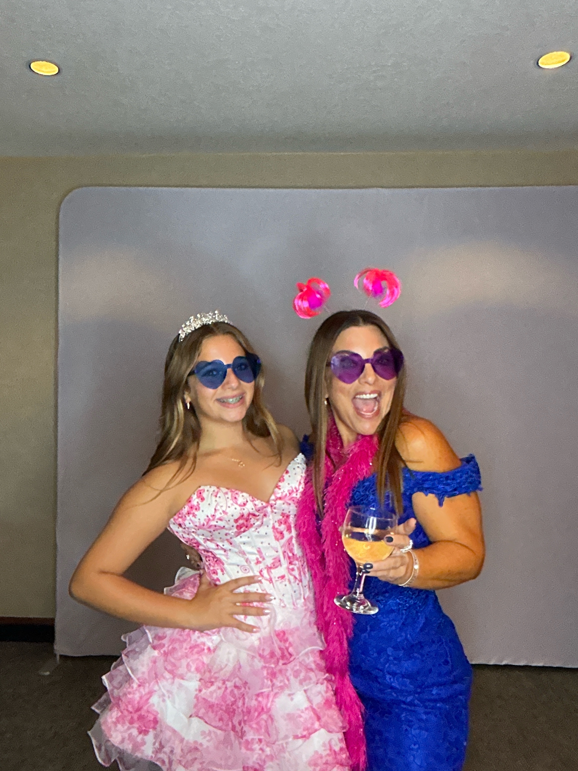 Guests posing in a Picture Perfect Events photo booth at a graduation-style party
