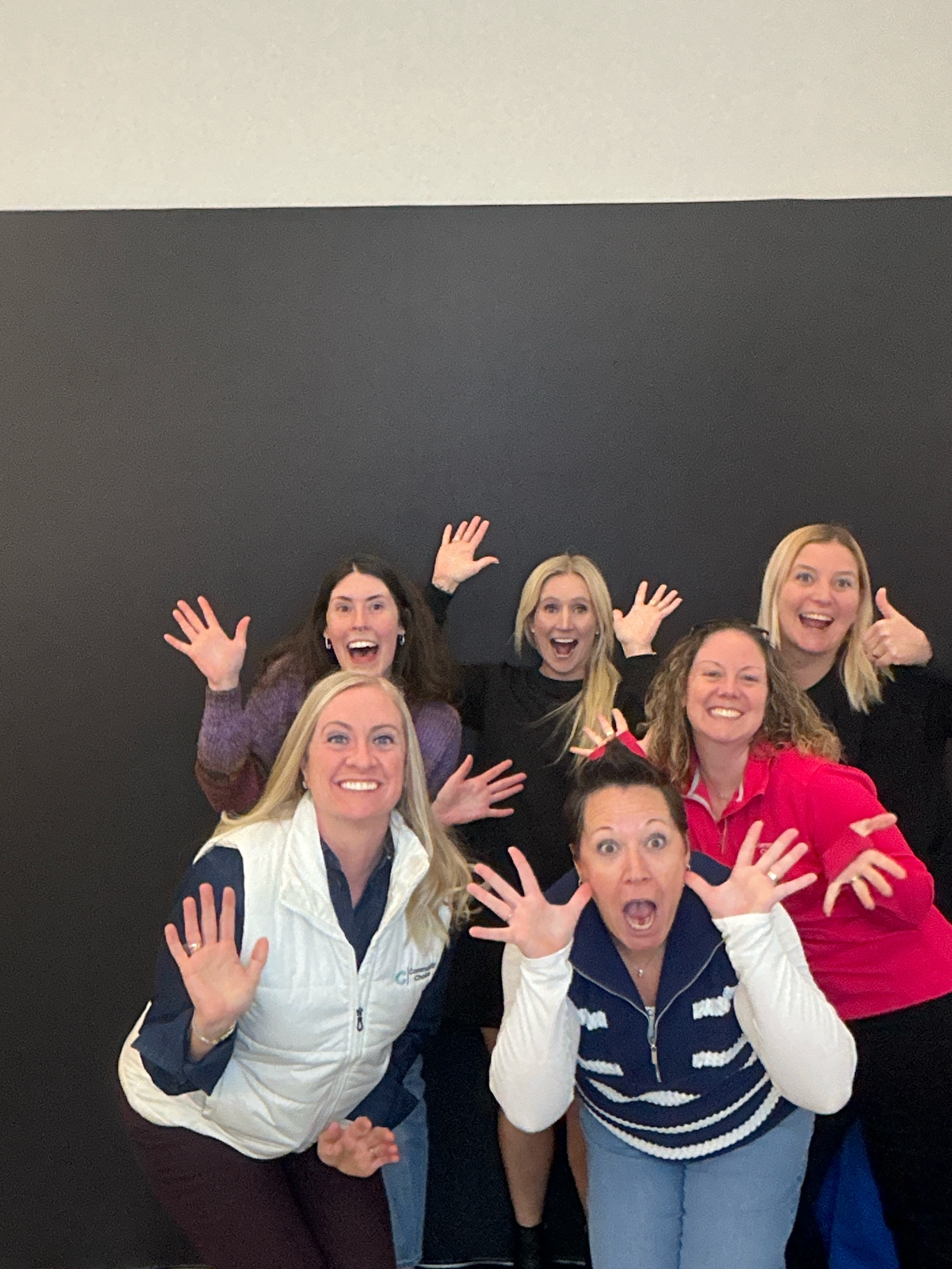 Office party guests posing in the Picture Perfect Events photo booth