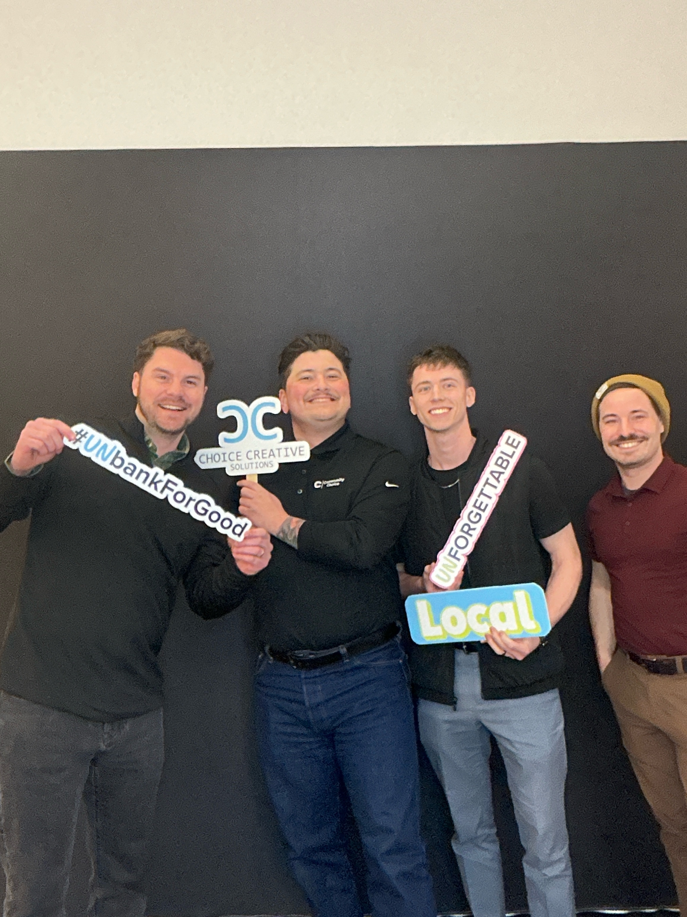 Corporate guests with branded props in a Picture Perfect Events photo booth